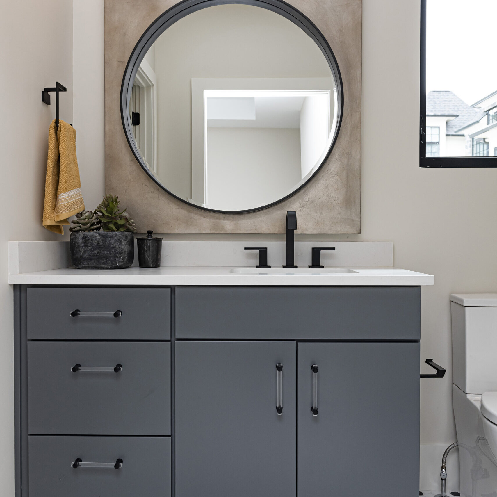 A bathroom with black and white polka dot tile.