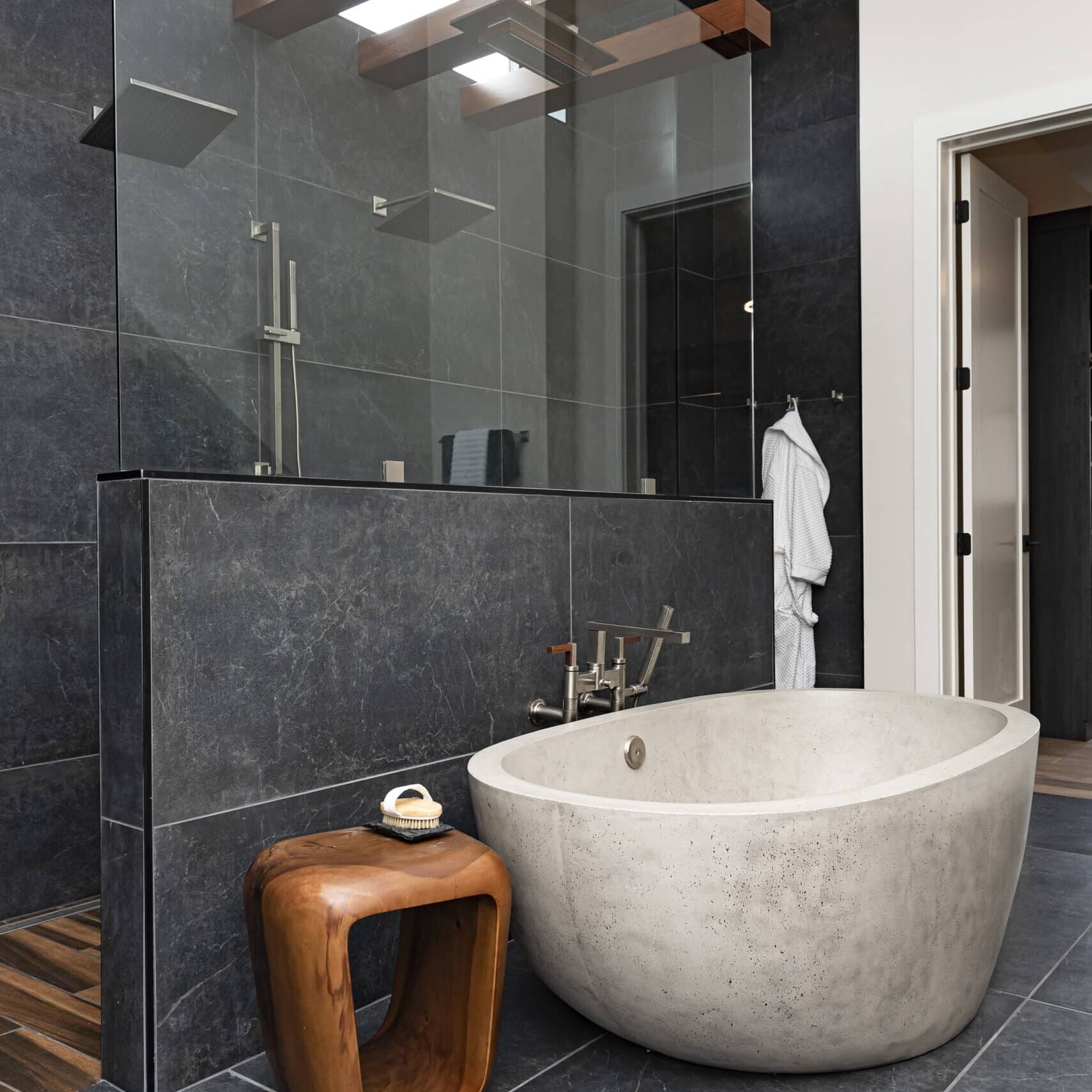 A bathroom with a large tub and a glass shower.