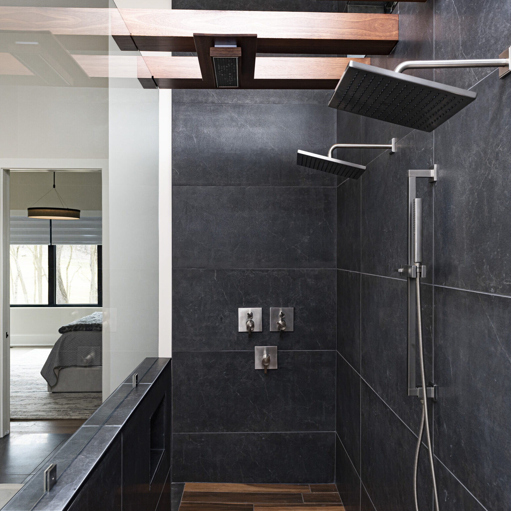 A bathroom with a shower and a wooden floor.