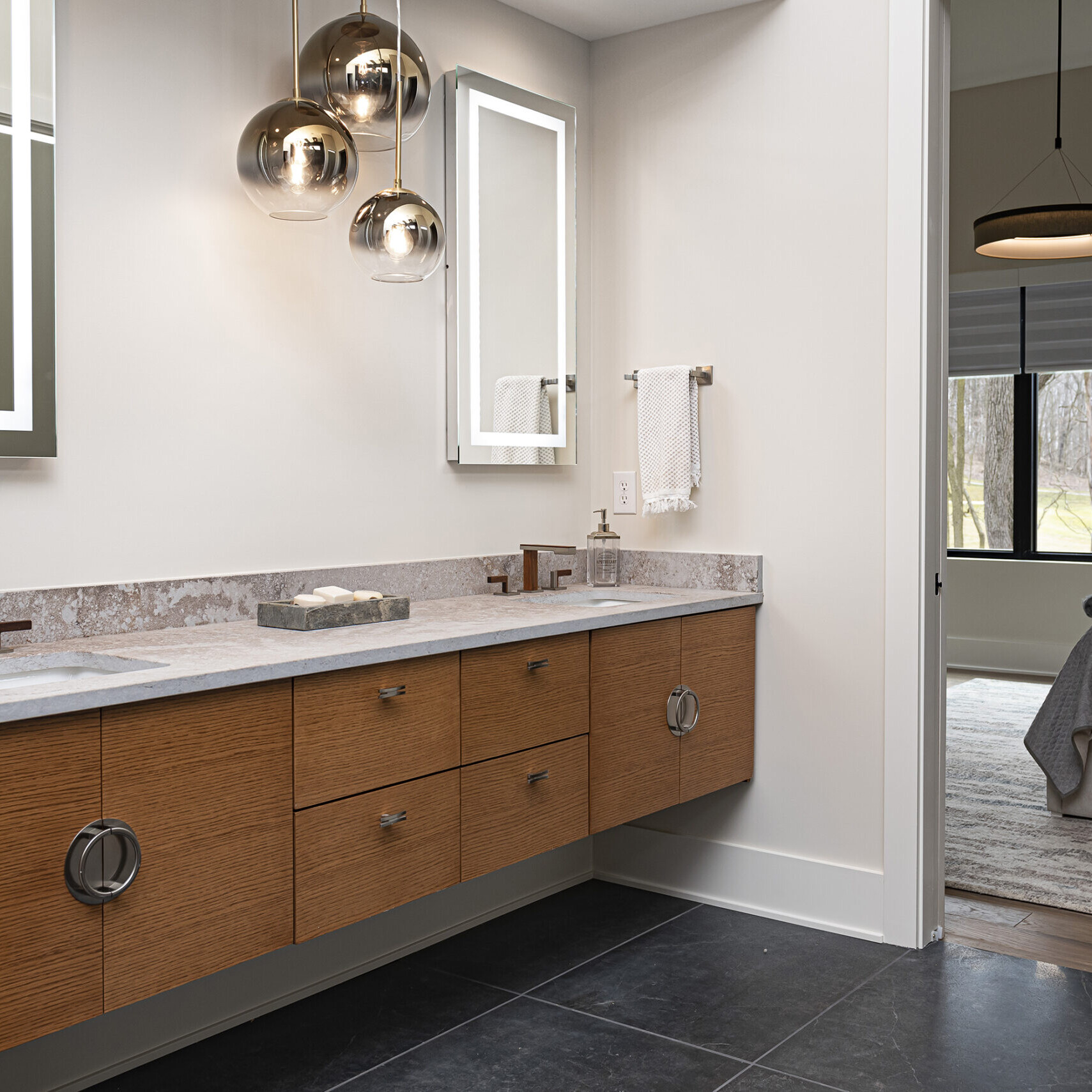 A bathroom with two sinks and a mirror.