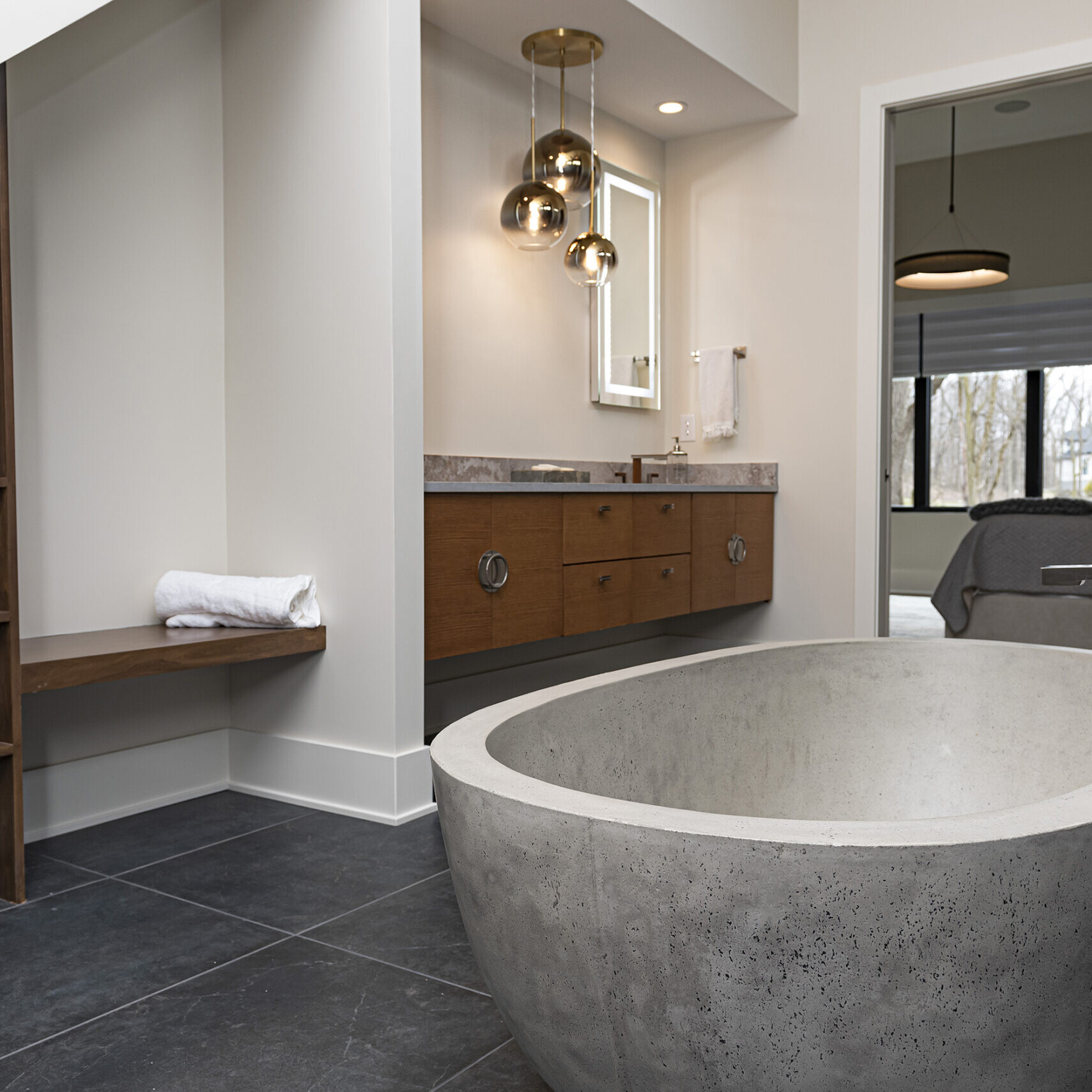 A bathroom with a large concrete tub.