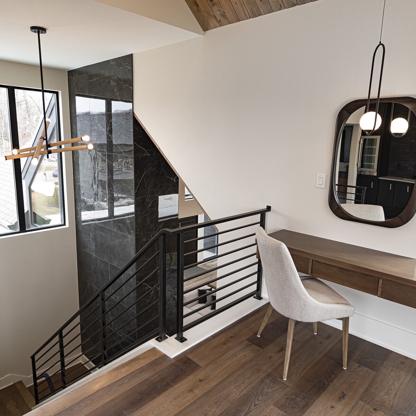 A modern home with a staircase and a desk.