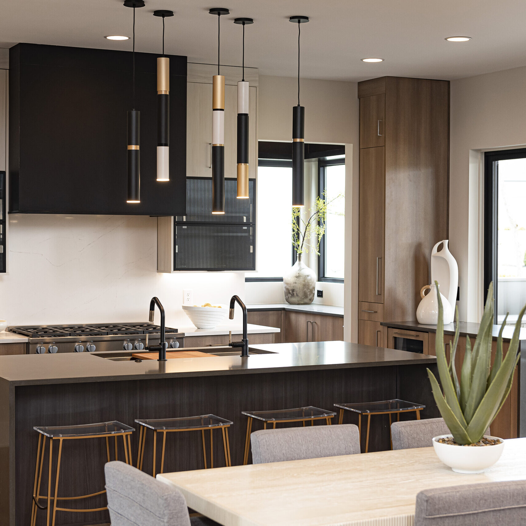 A modern kitchen with a table and chairs.