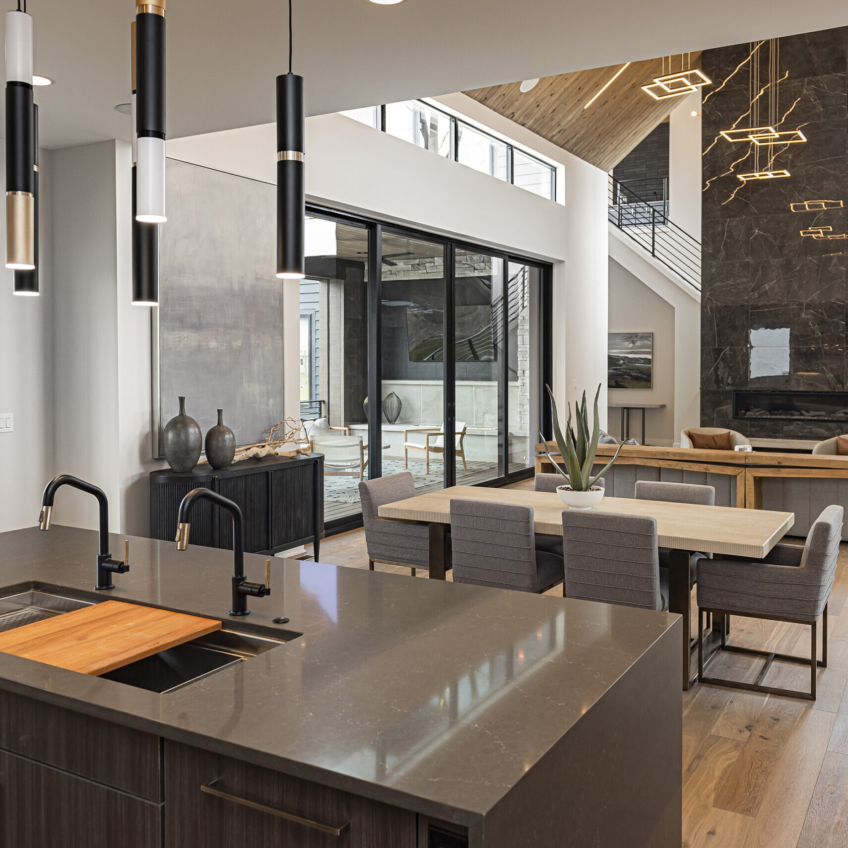 A modern kitchen with a large island and a fireplace.