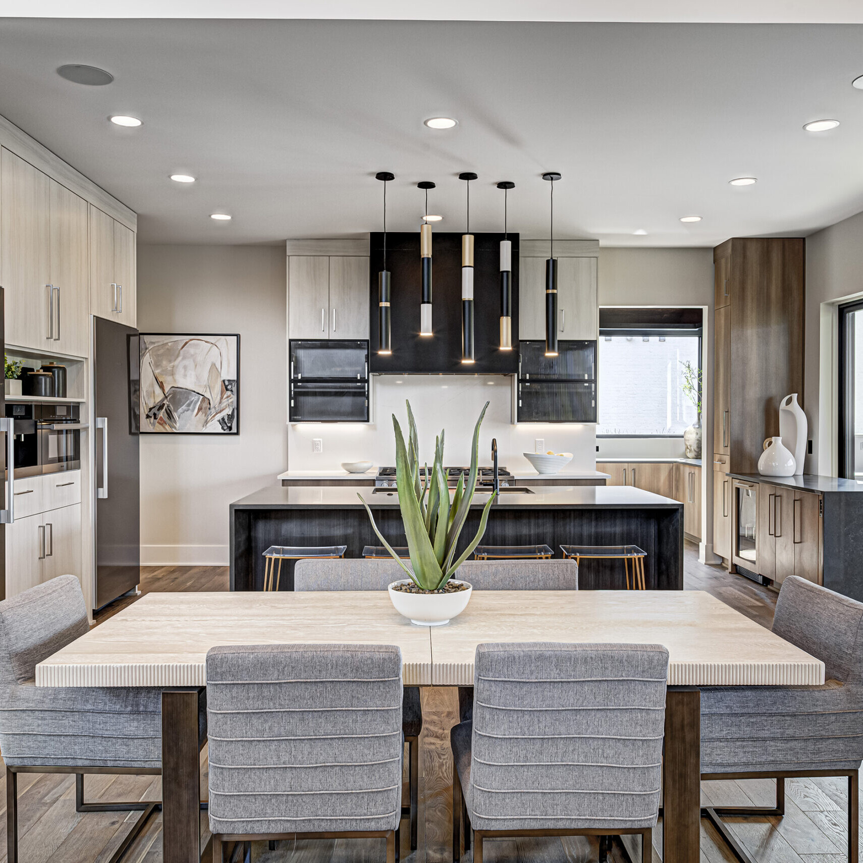 A modern kitchen with a dining table and chairs.