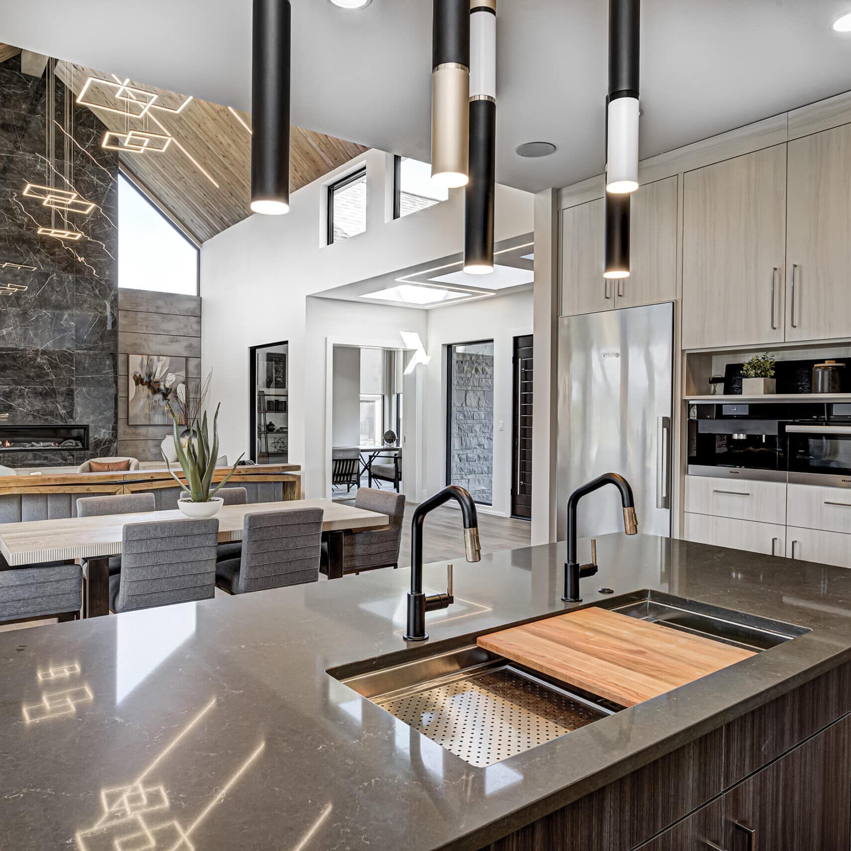 A modern kitchen with a large island and stainless steel appliances.