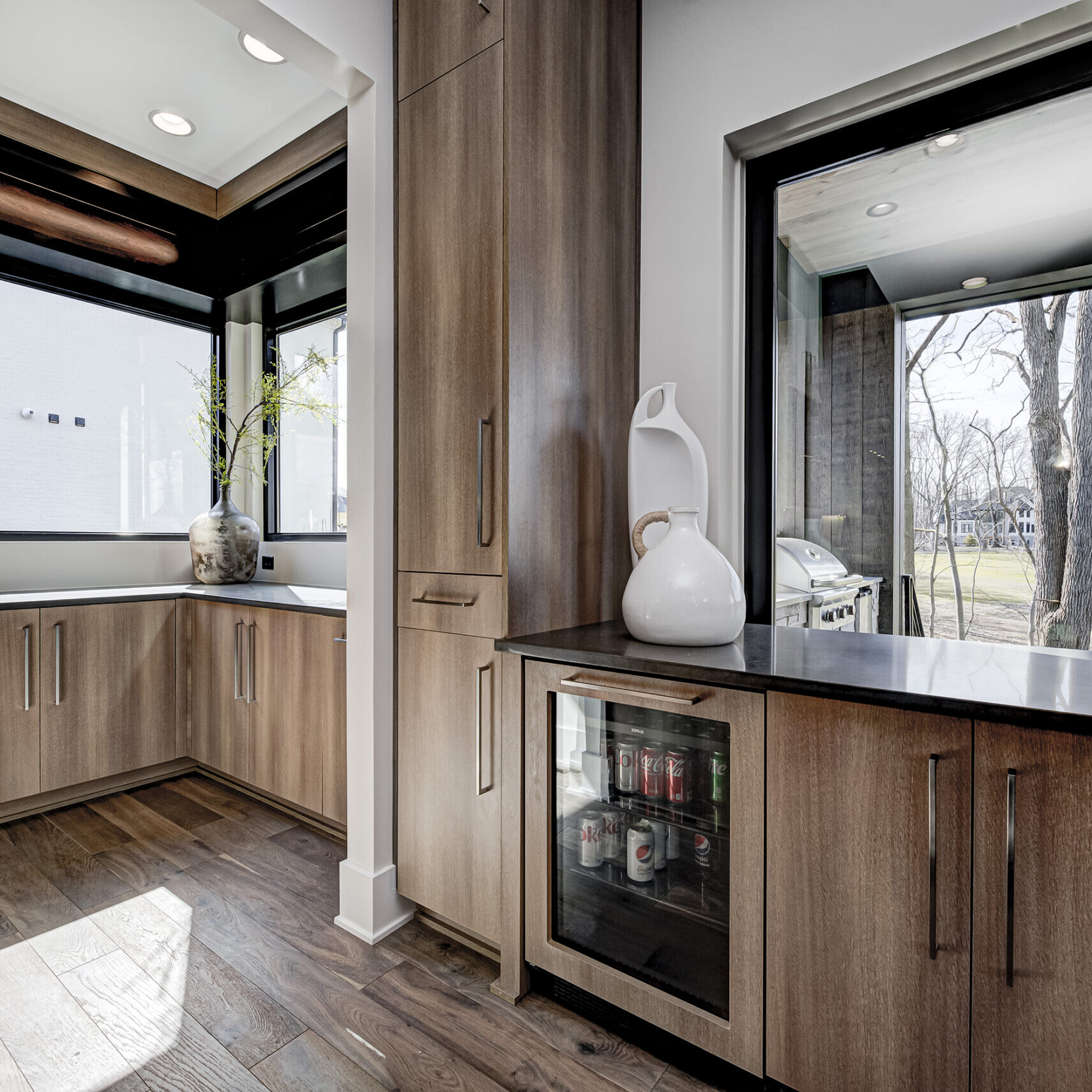 A kitchen with wood cabinets and a window.