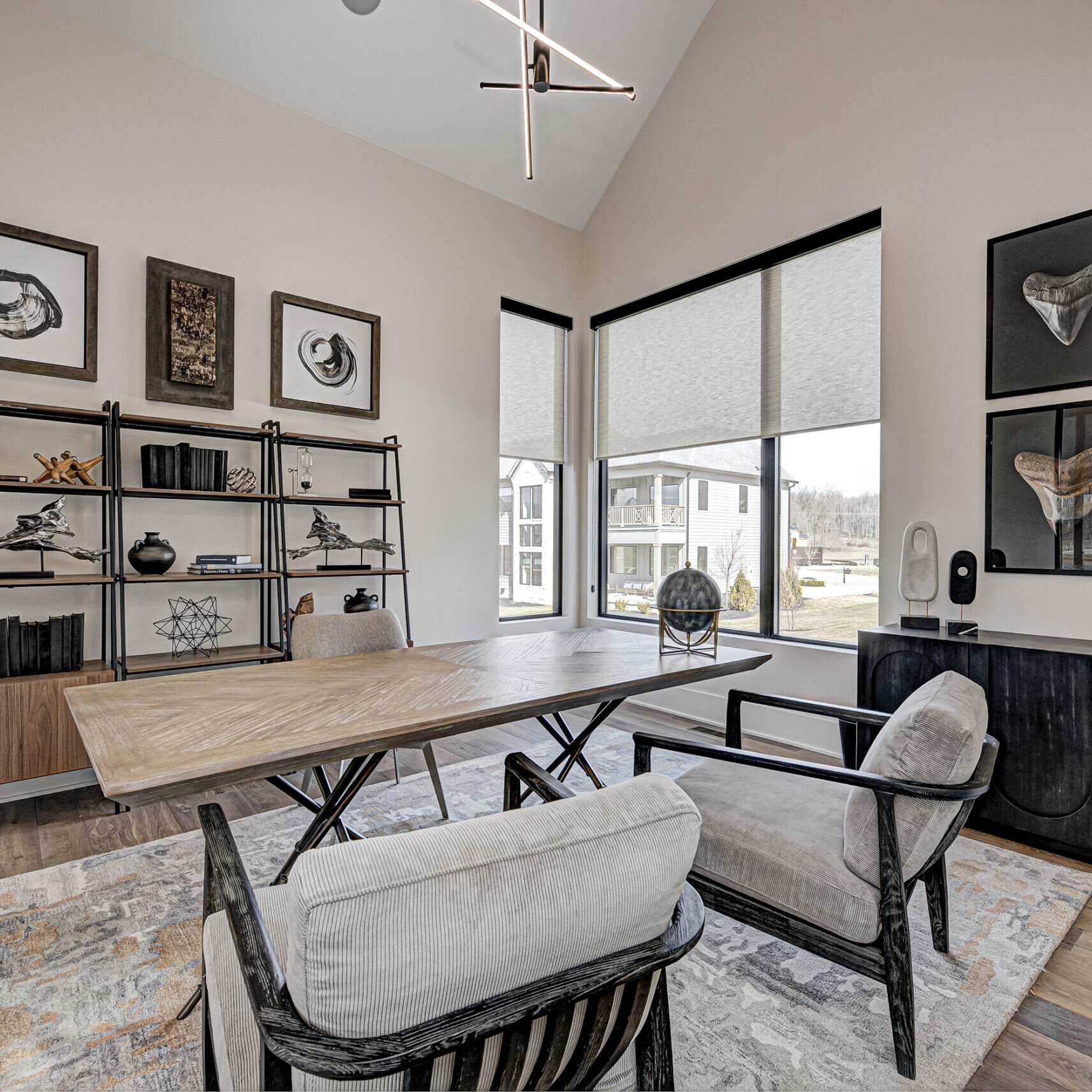 A home office with a desk and chairs.