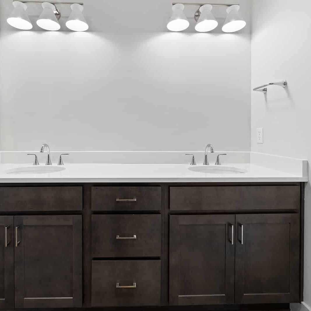A bathroom with two sinks and a mirror in a custom home built by a reputable builder in Carmel, Indiana.