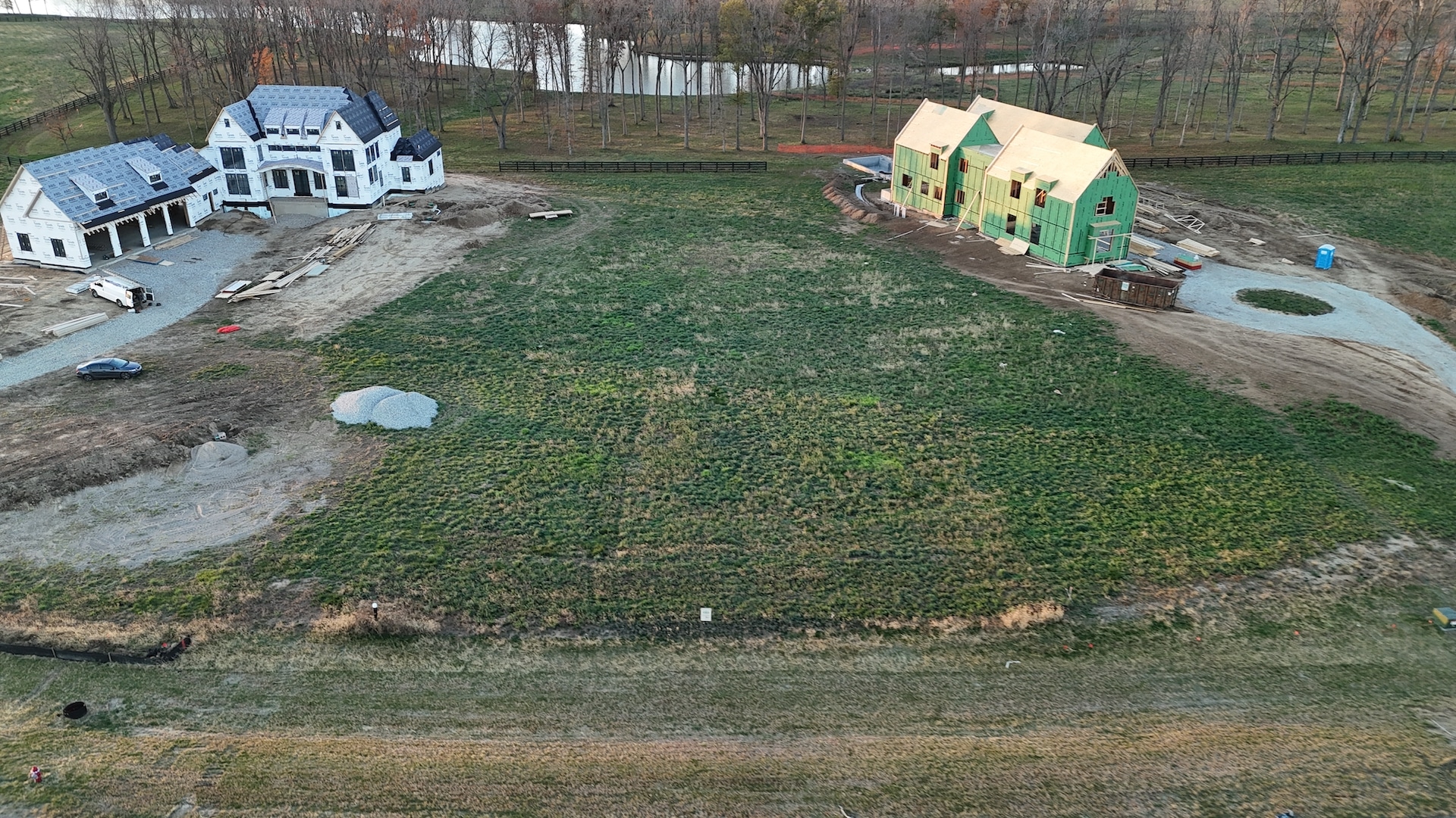 An aerial view of a custom home and surrounding field in Carmel Indiana.