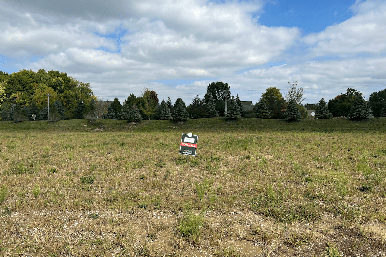 A field with a sign in the middle of it, located in Carmel, Indiana.