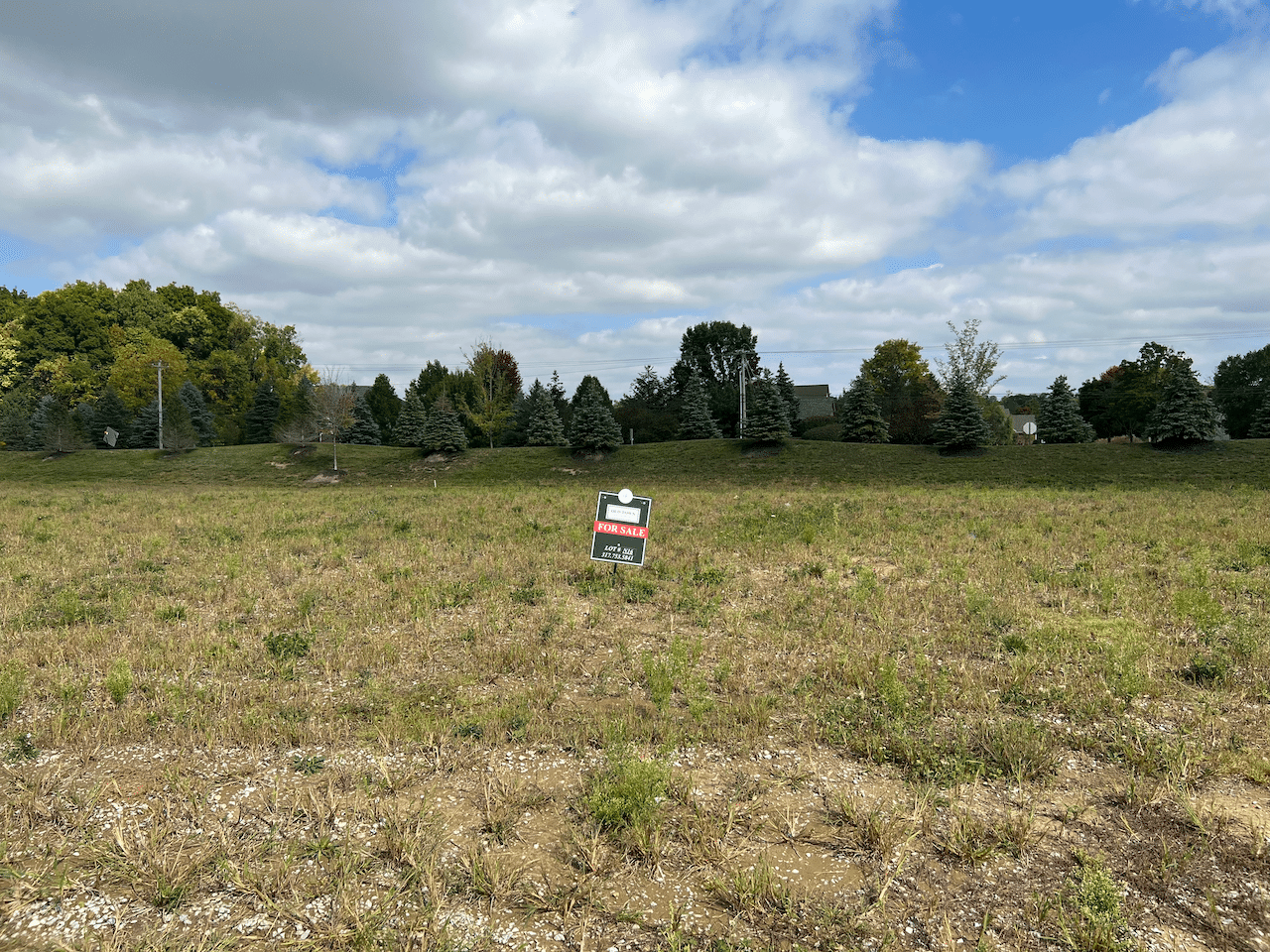 A field with a sign in the middle of it, located in Carmel, Indiana.