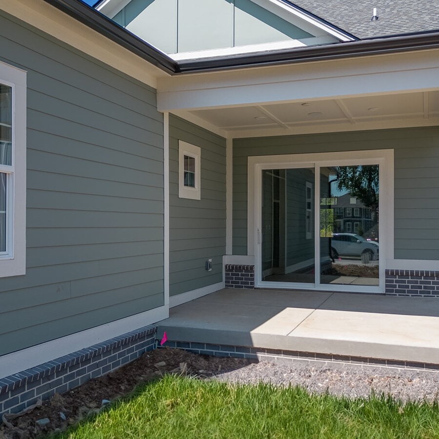 The front porch of a home with gray siding, built by a luxury custom home builder in Westfield Indiana.