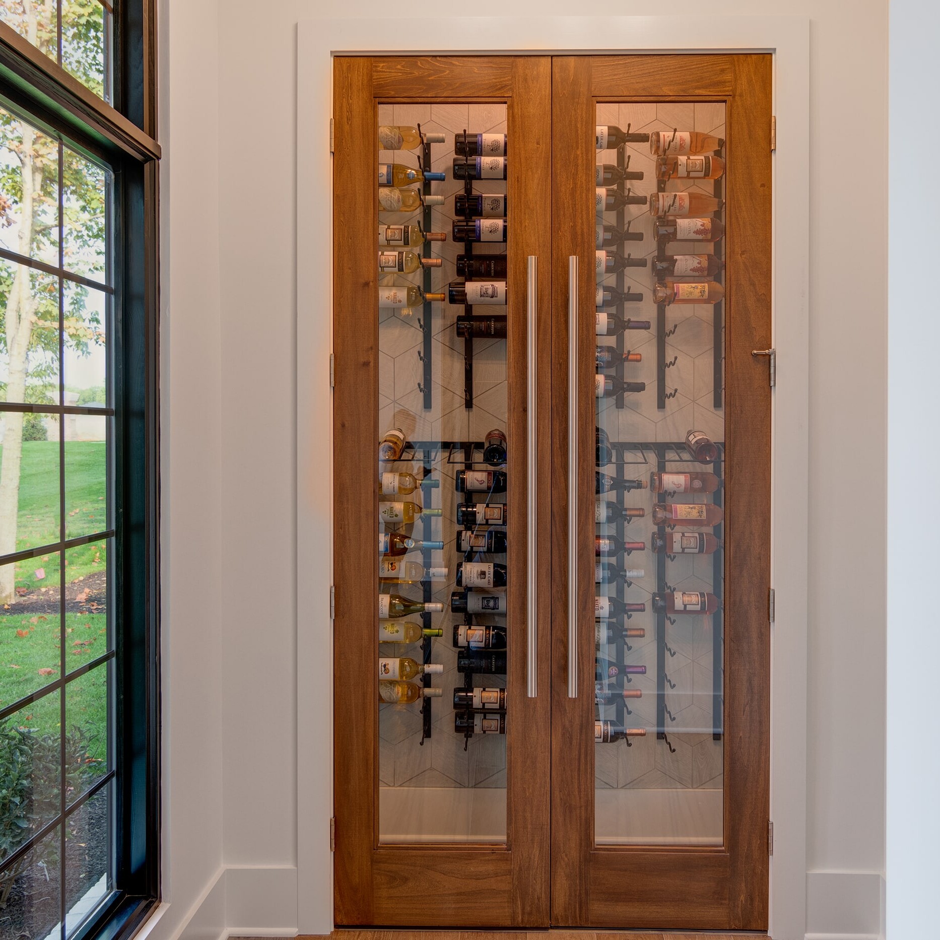 A wooden wine rack in a room with a window.