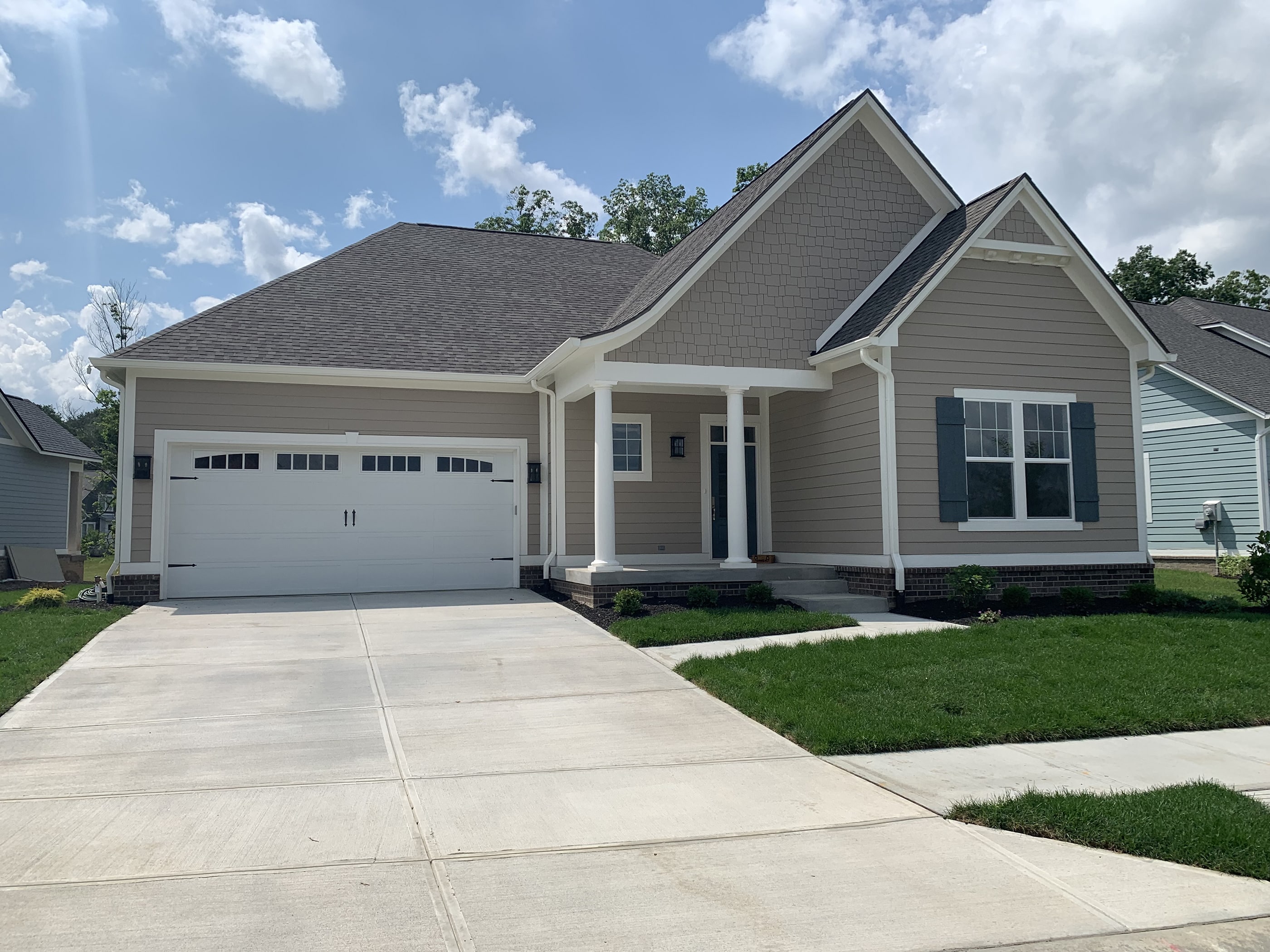 A custom home with two garages and a driveway in Westfield, Indiana.
