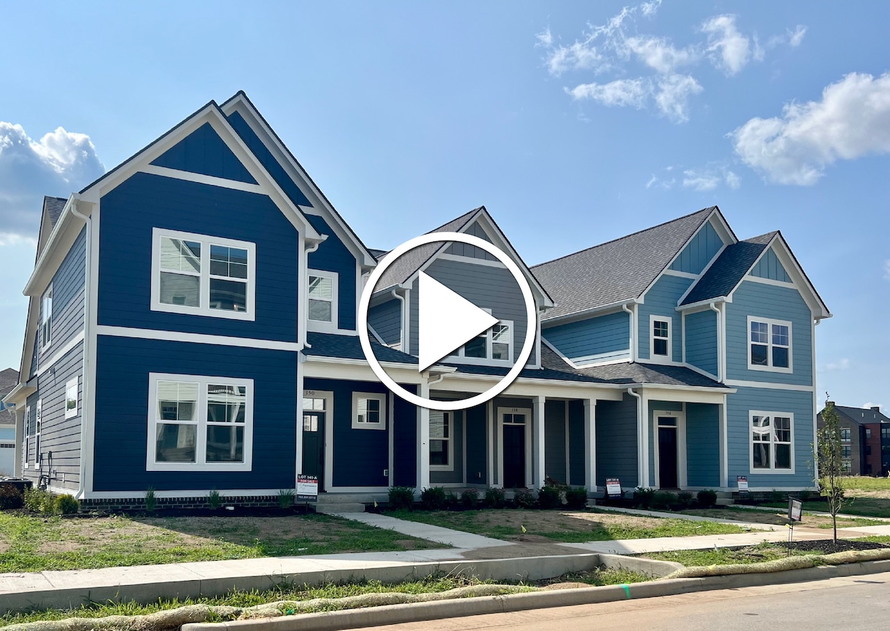 A video showcasing the exterior of a new blue house built by a custom home builder in Carmel Indiana.