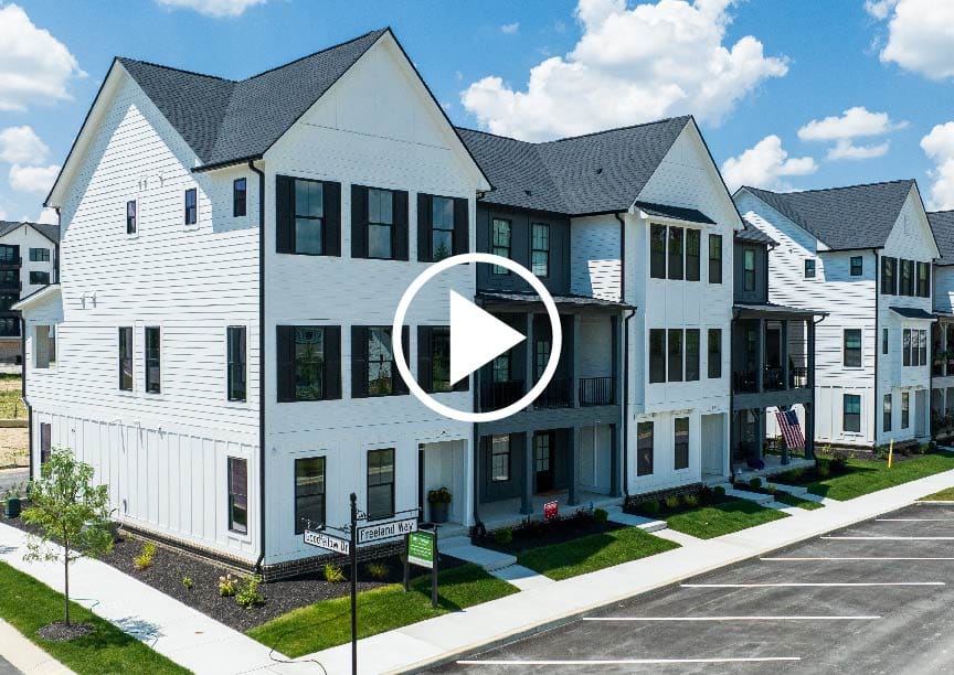 A custom homes virtual tour showcasing a row of townhomes in a parking lot.