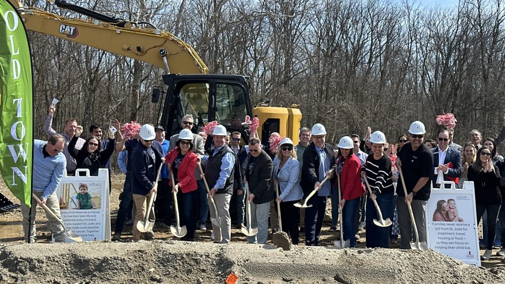 Groundbreaking ceremony for the St. Jude Dream Home, with a crowd in hard hats holding shovels